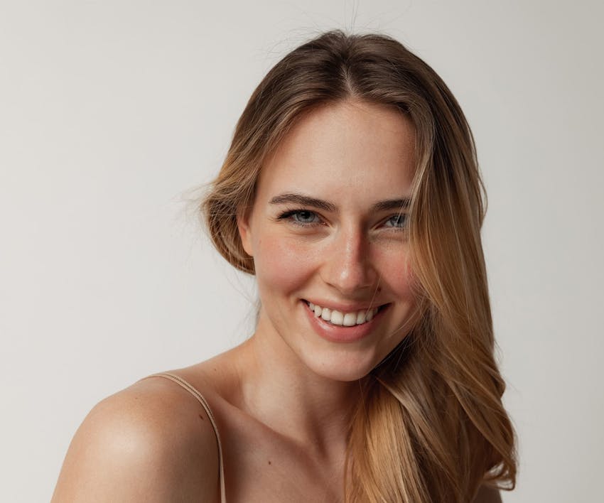 woman smiling with her hair over her shoulder