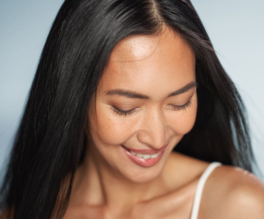 woman smiling and looking downward