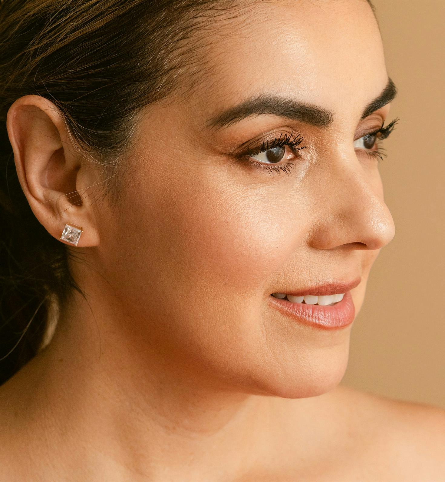 close up on womans face facing the right