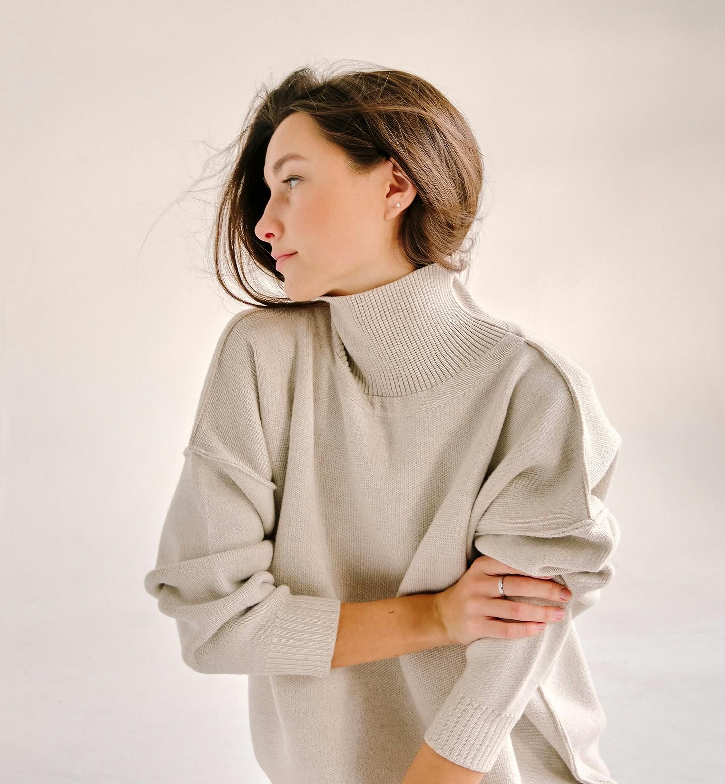 woman in grey matching outfit while crouched on the floor