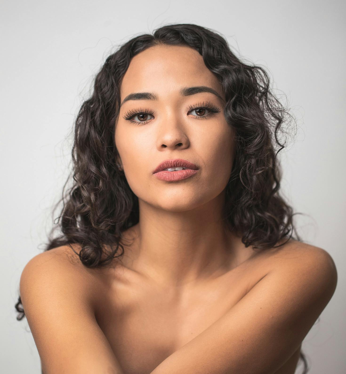 woman with long wavy hair facing forward