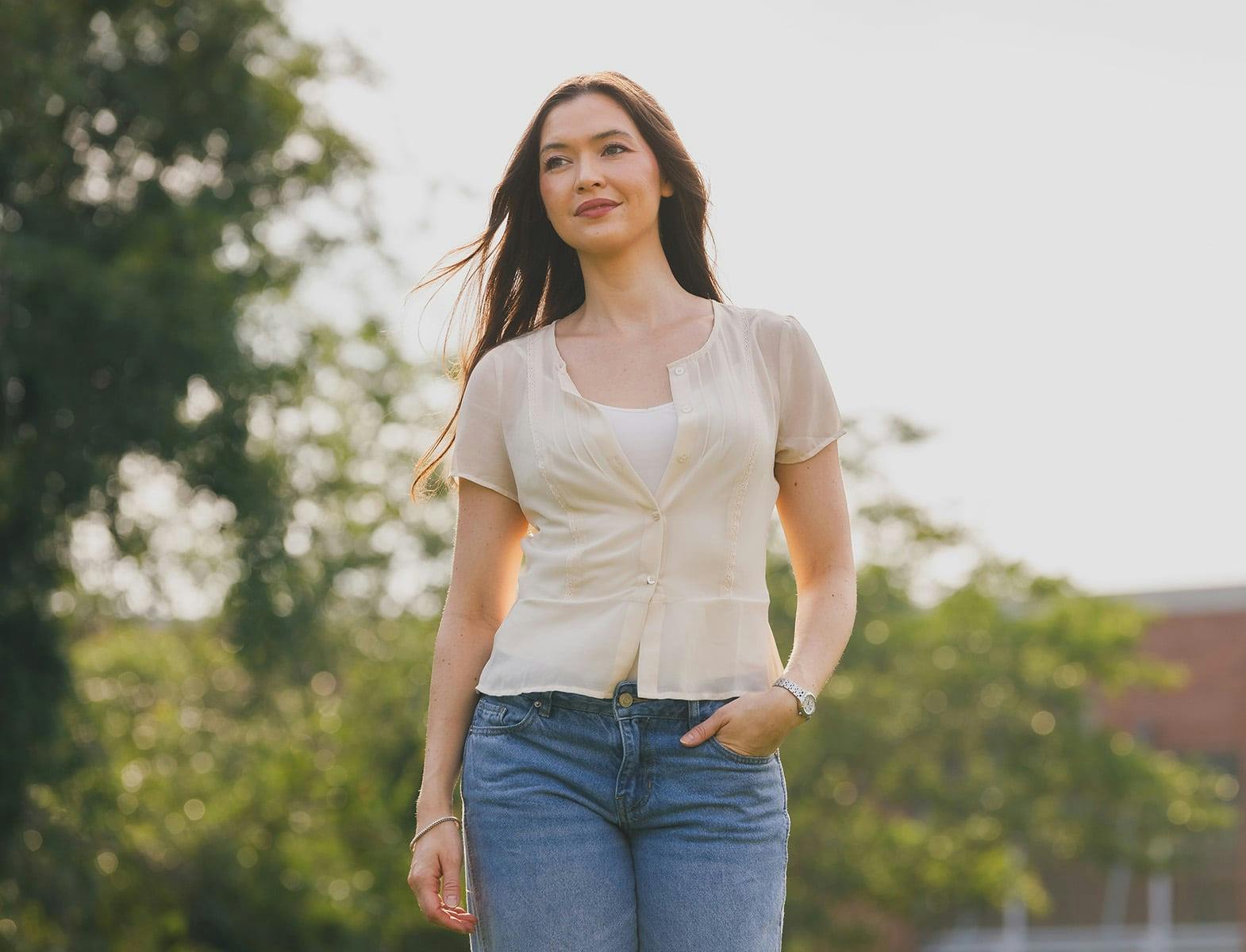woman outside in casual clothing with her hand in her front jean pocket