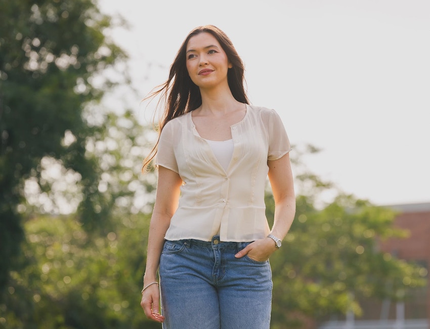 woman outside in casual clothing with her hand in her front jean pocket