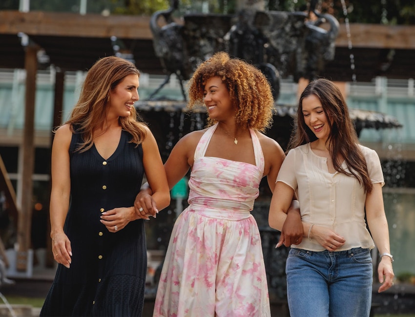 3 ladies outside linking arms together