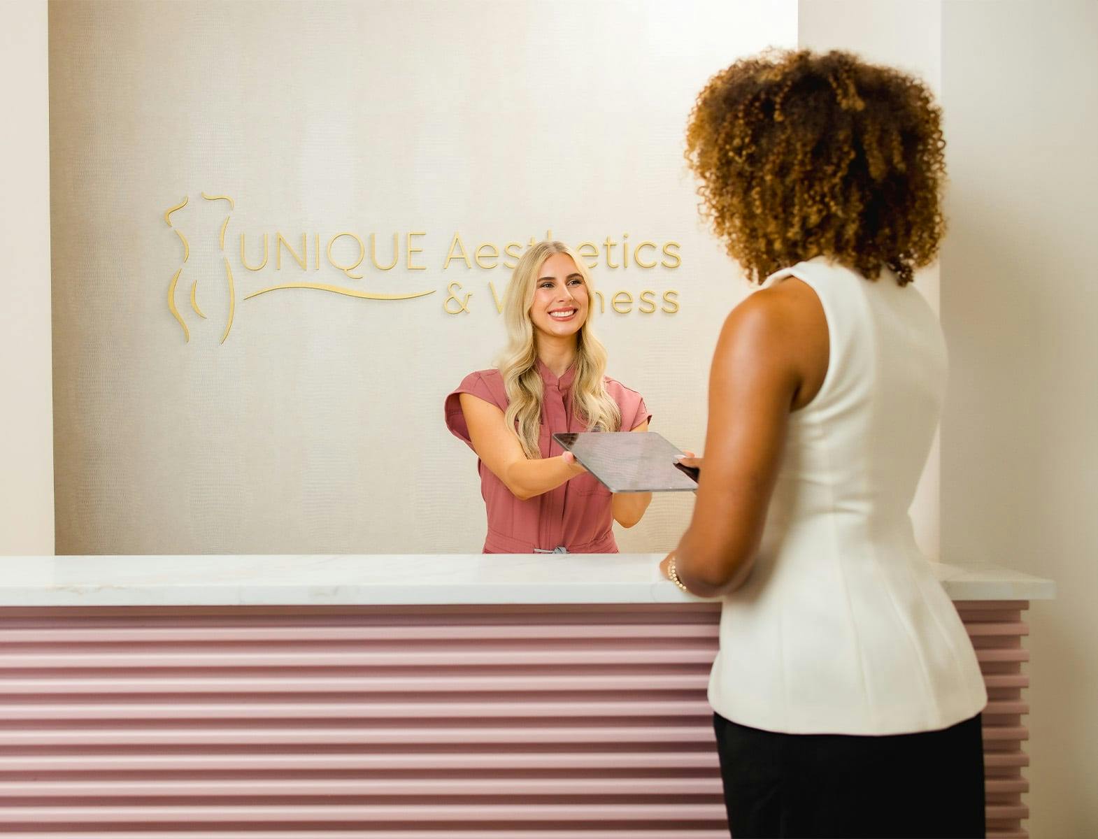 receptionist handing ipad to patient