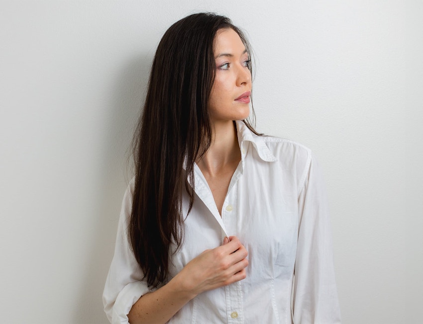 woman with long straight hair facing to the right