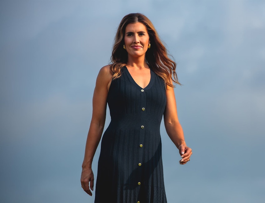woman in navy blue dress outside