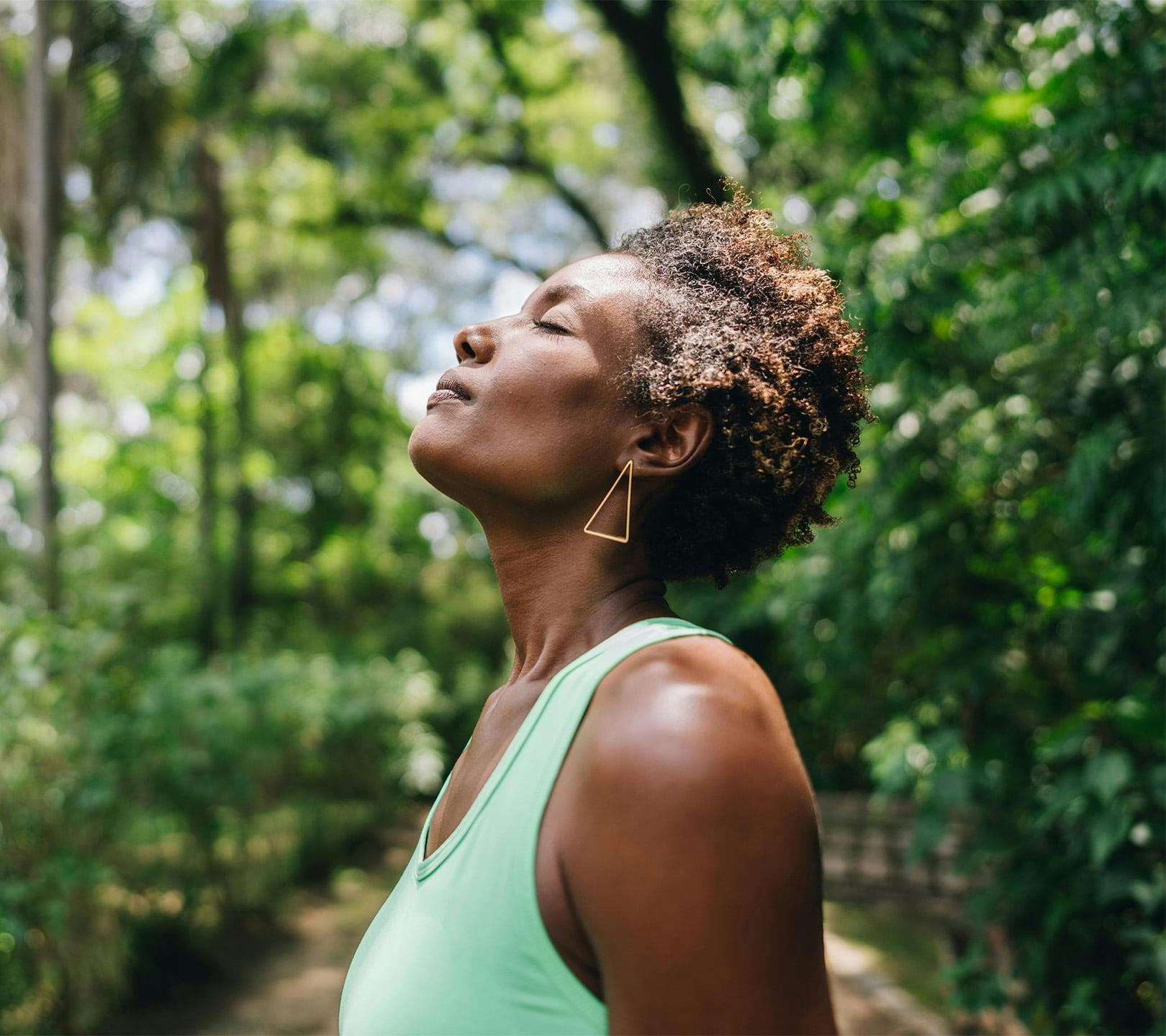 woman outside with her head facing upwards