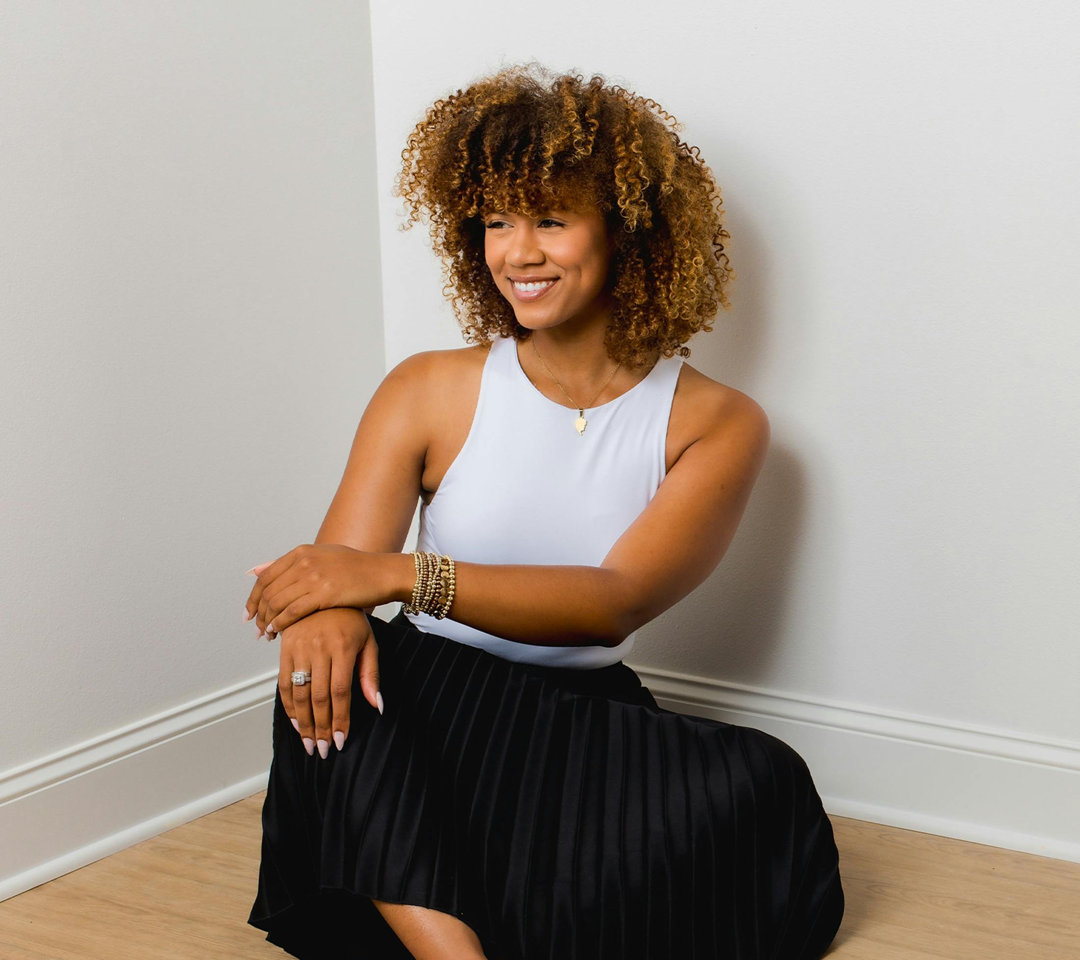 woman sitting on the floor and smiling