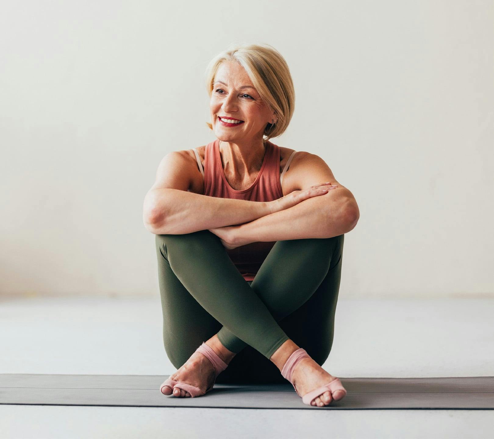 woman sitting on the floor with her legs crossed
