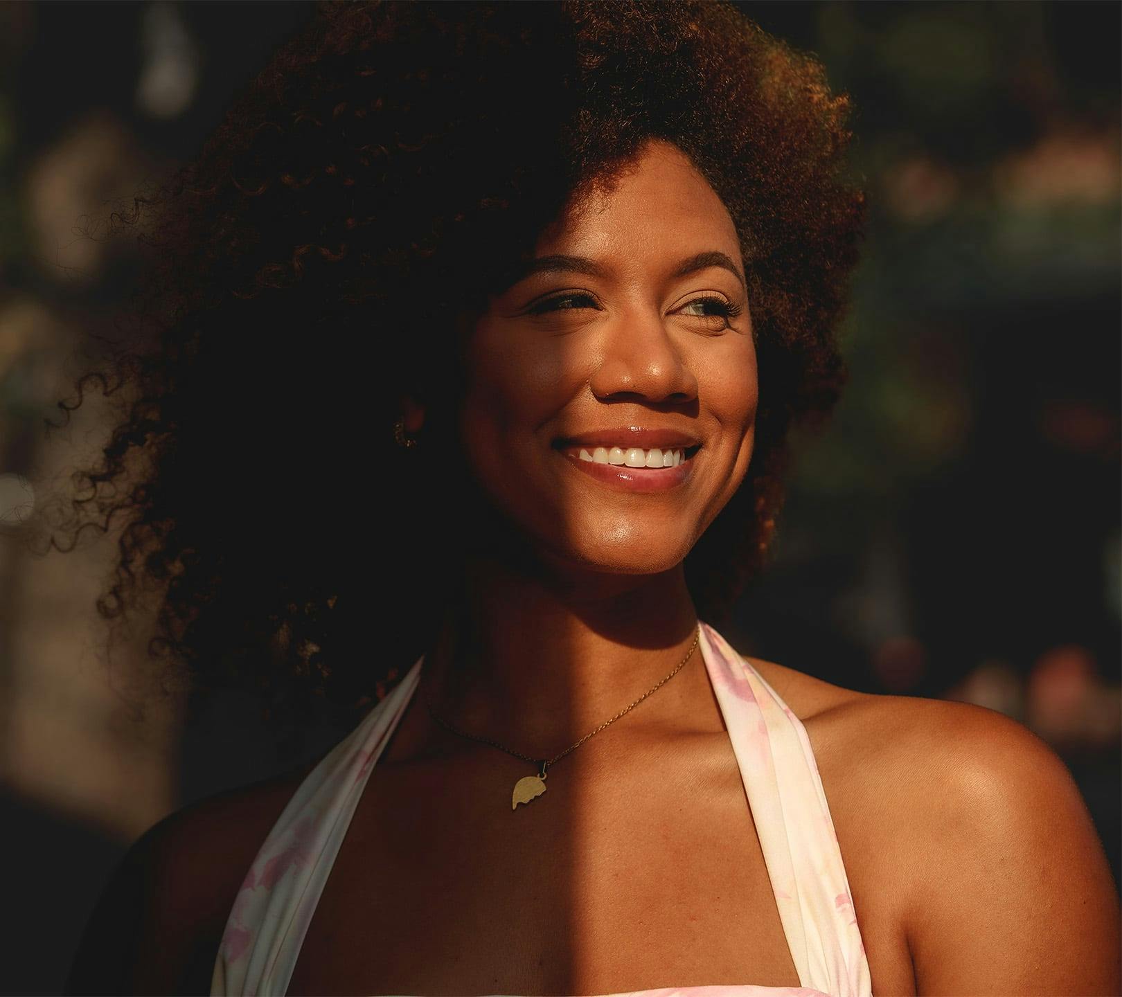 woman smiling with the sunset light hitting her face