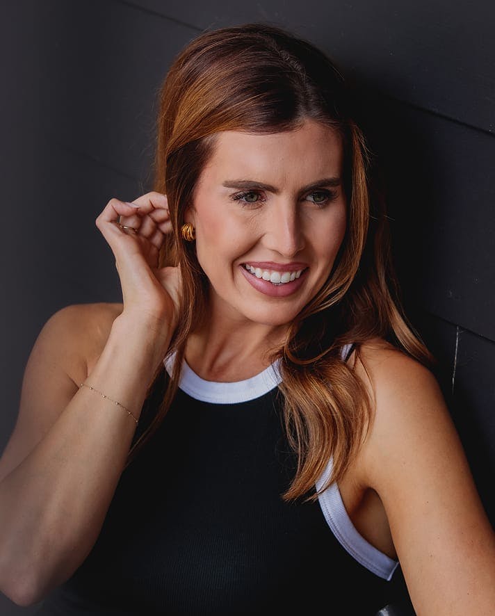 Smiling woman with long hair looking to the side