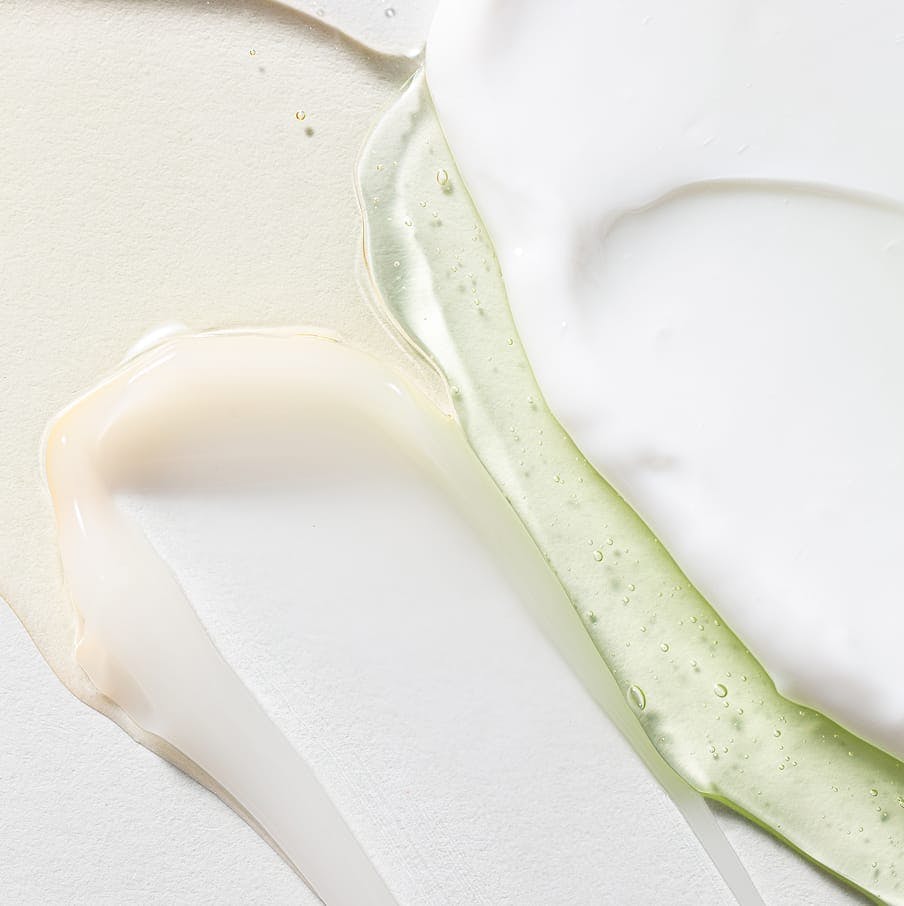 Creams and aloe on smooth surface