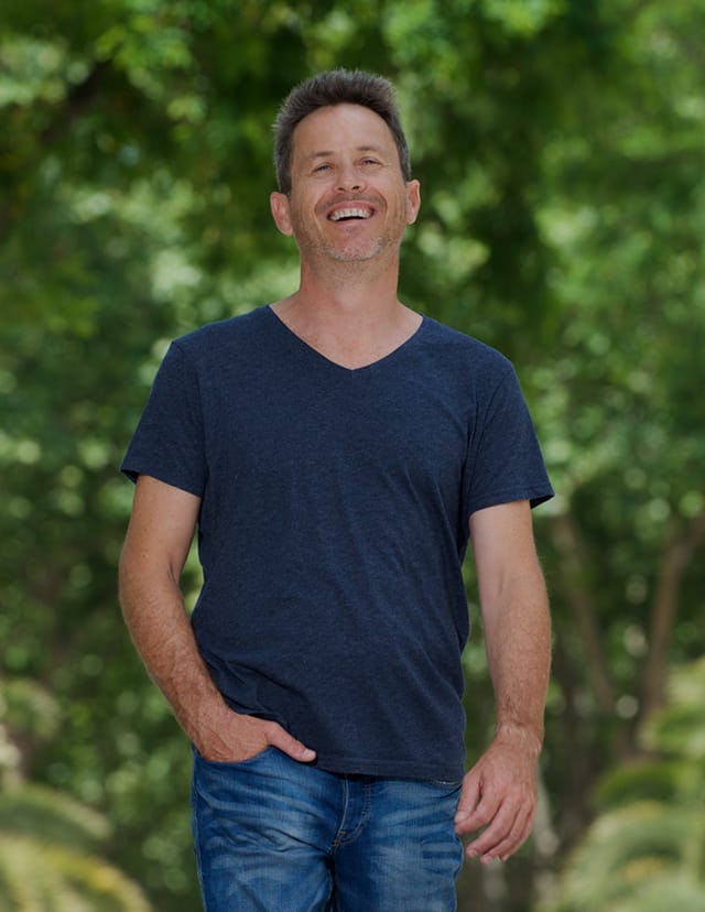 Man standing outdoors smiling