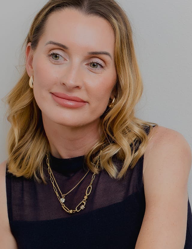 Smiling blonde woman with visible skin treatments