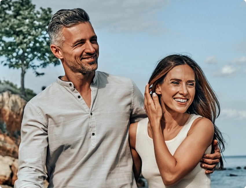 woman and man walking on a beach
