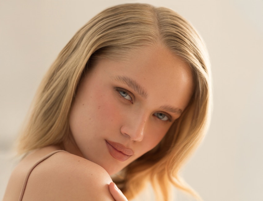 Blonde woman looking over shoulder