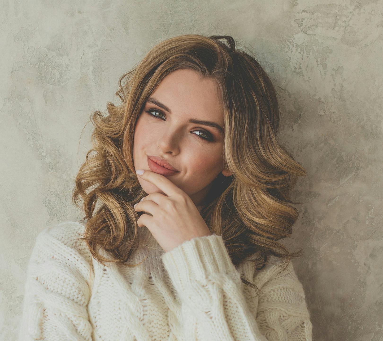 Woman smiling while touching chin