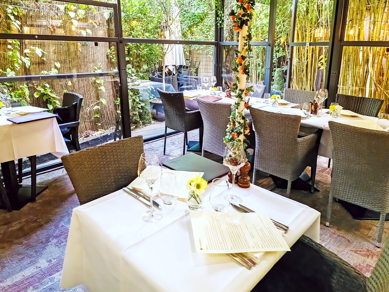 furniture, table, dining table, indoors, restaurant, flower arrangement