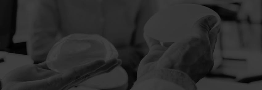 doctor holding breast implants