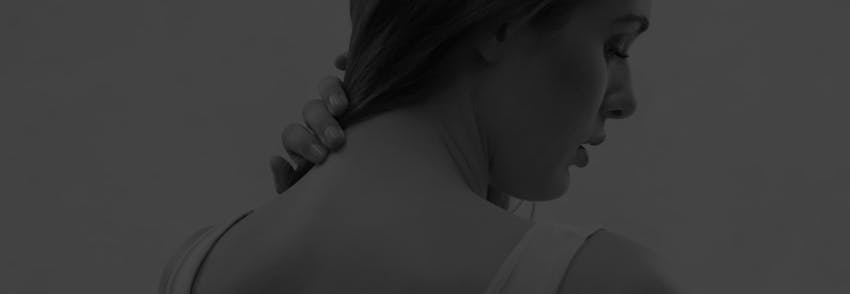 woman holding her neck