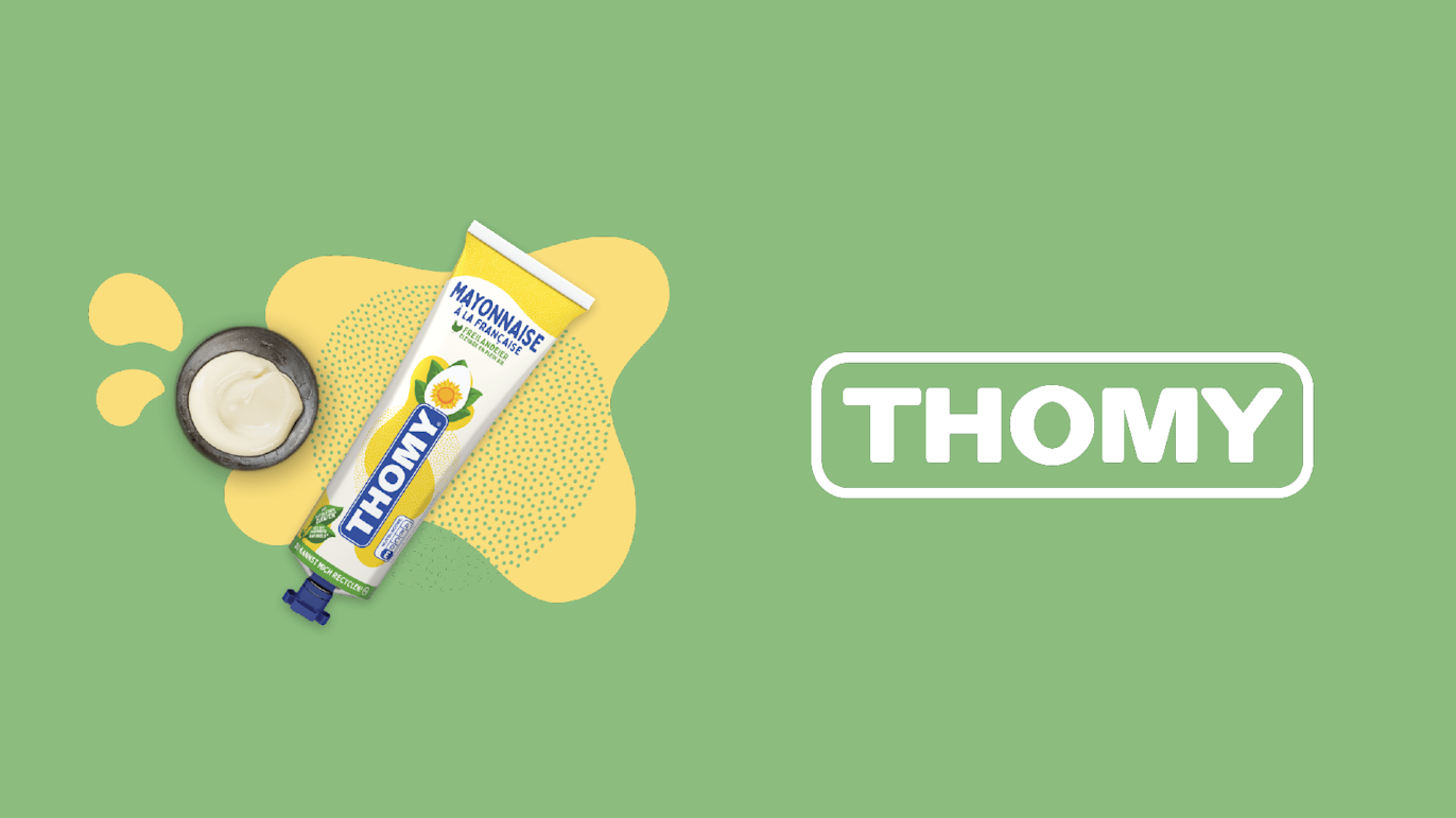 A tube of Thomy mayonnaise with an open cap and mayonnaise dollop is shown on a green background next to the Thomy logo.