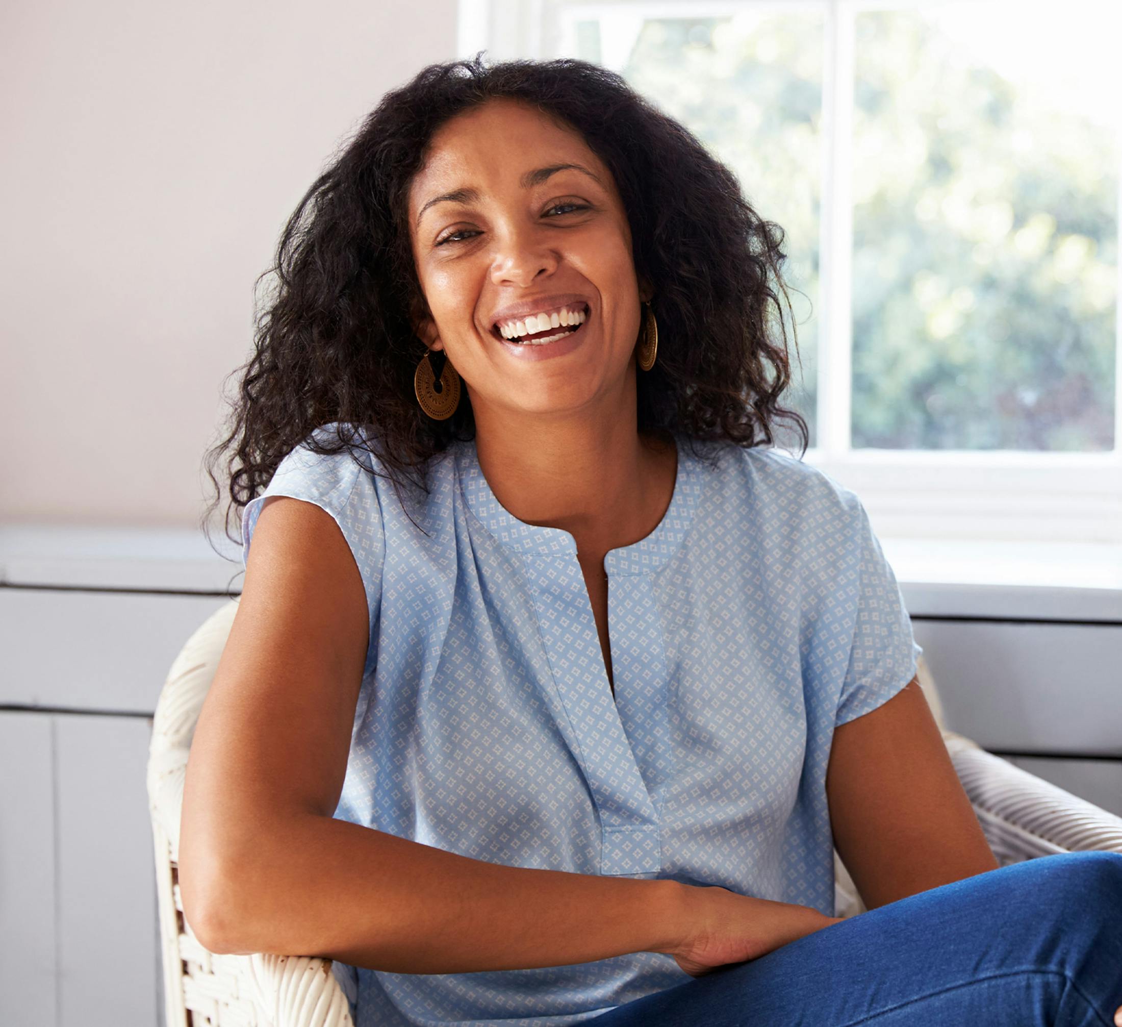 woman smiling while sitting in chair