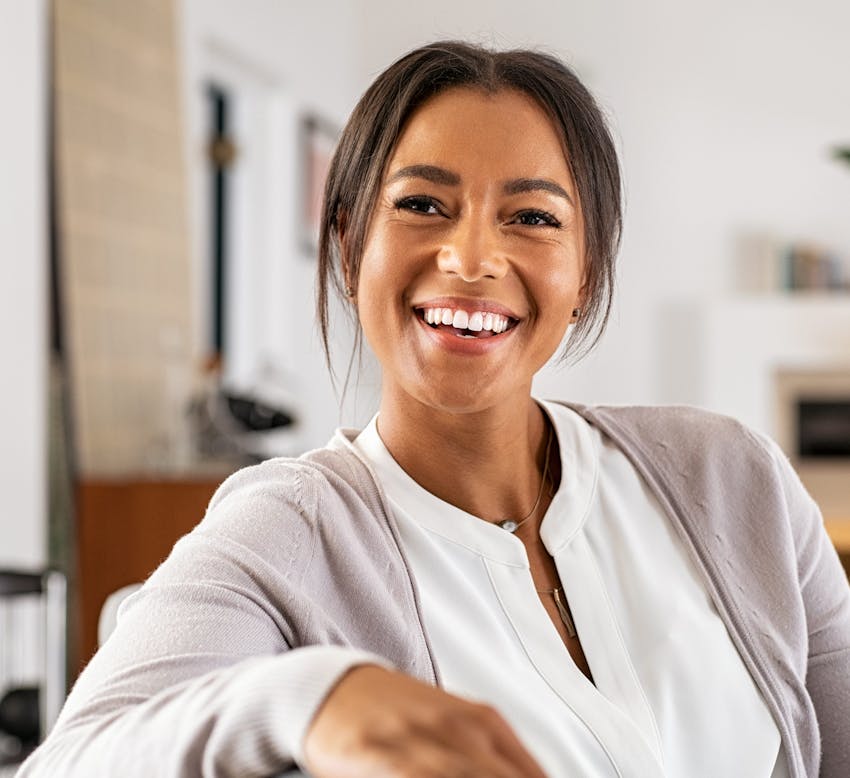 woman in white blouse with gray cardigan