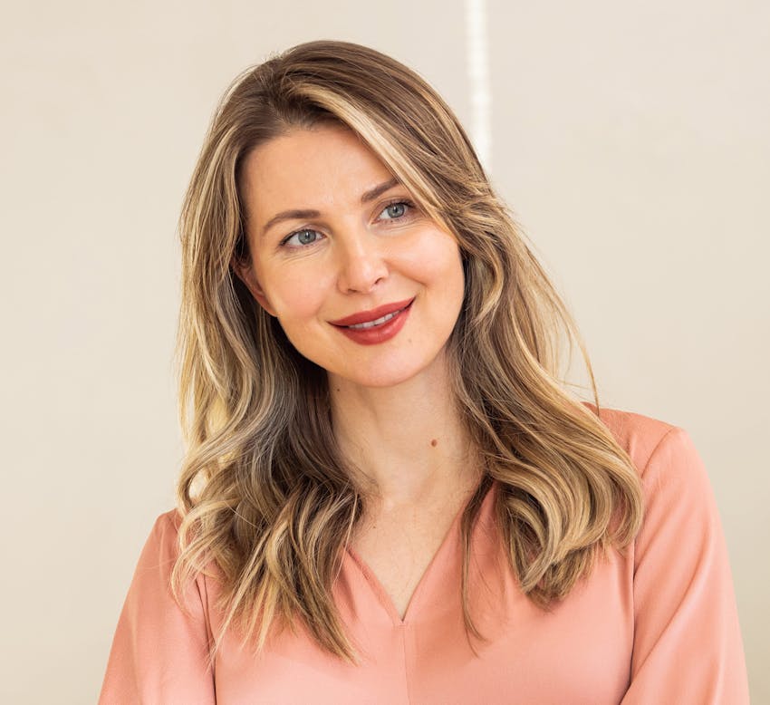 blonde woman wearing peach colored blouse