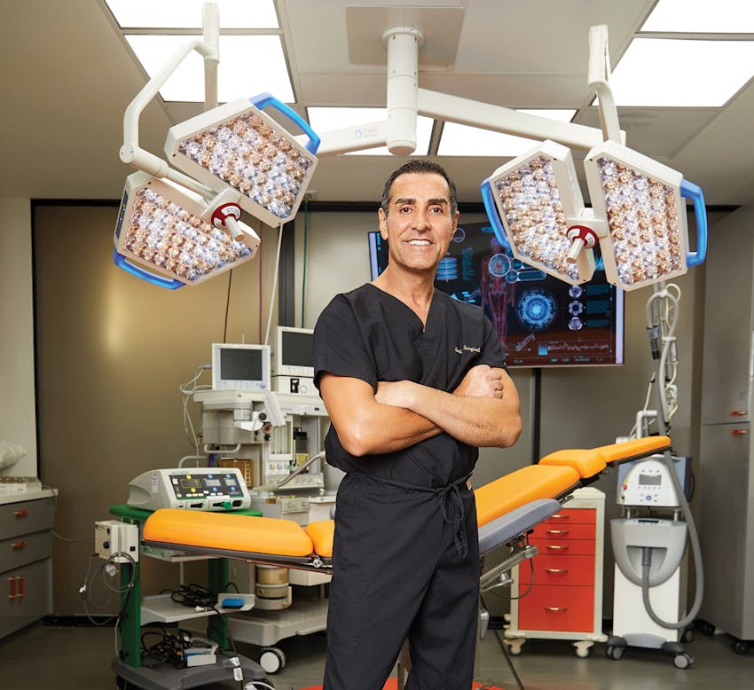 Dr. Kevin Sadart in front of surgical chair in surgical room