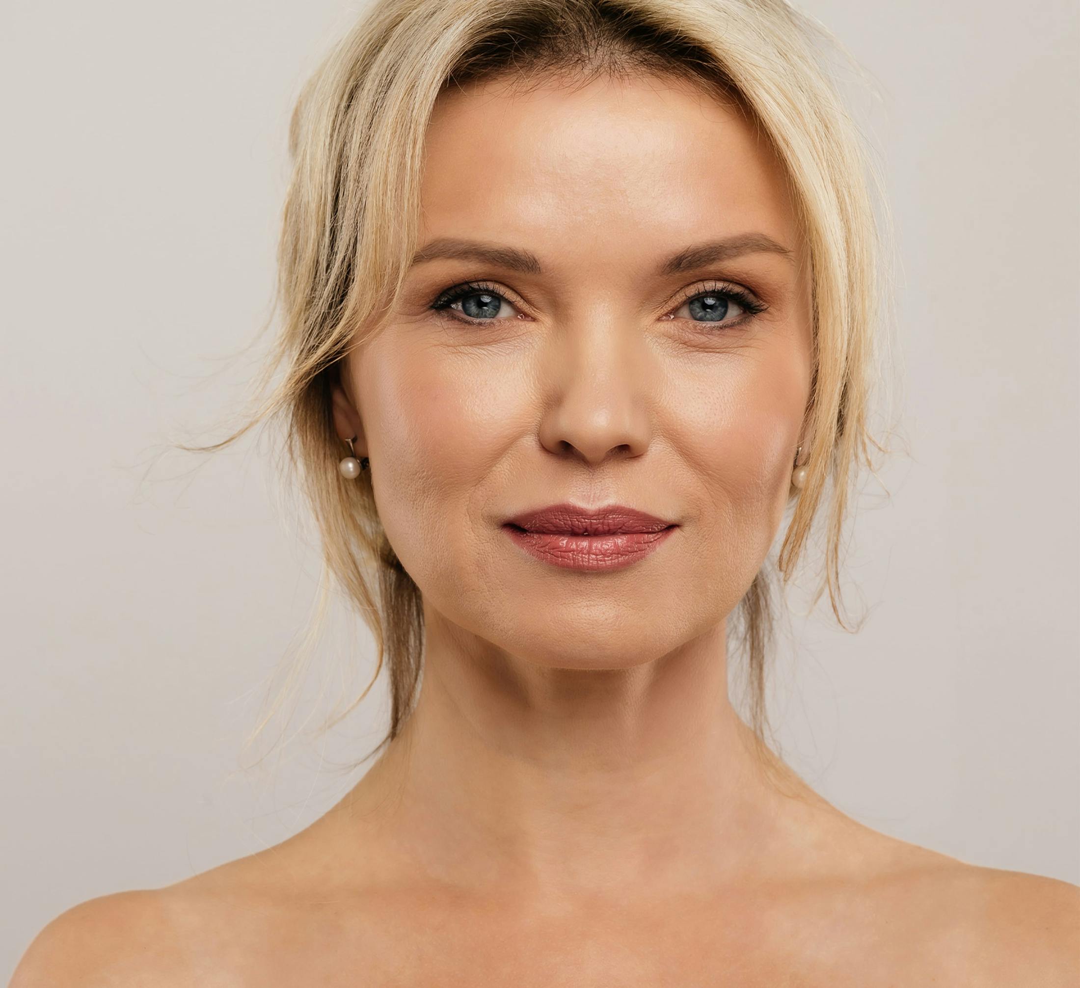 woman with short blonde hair looking forward