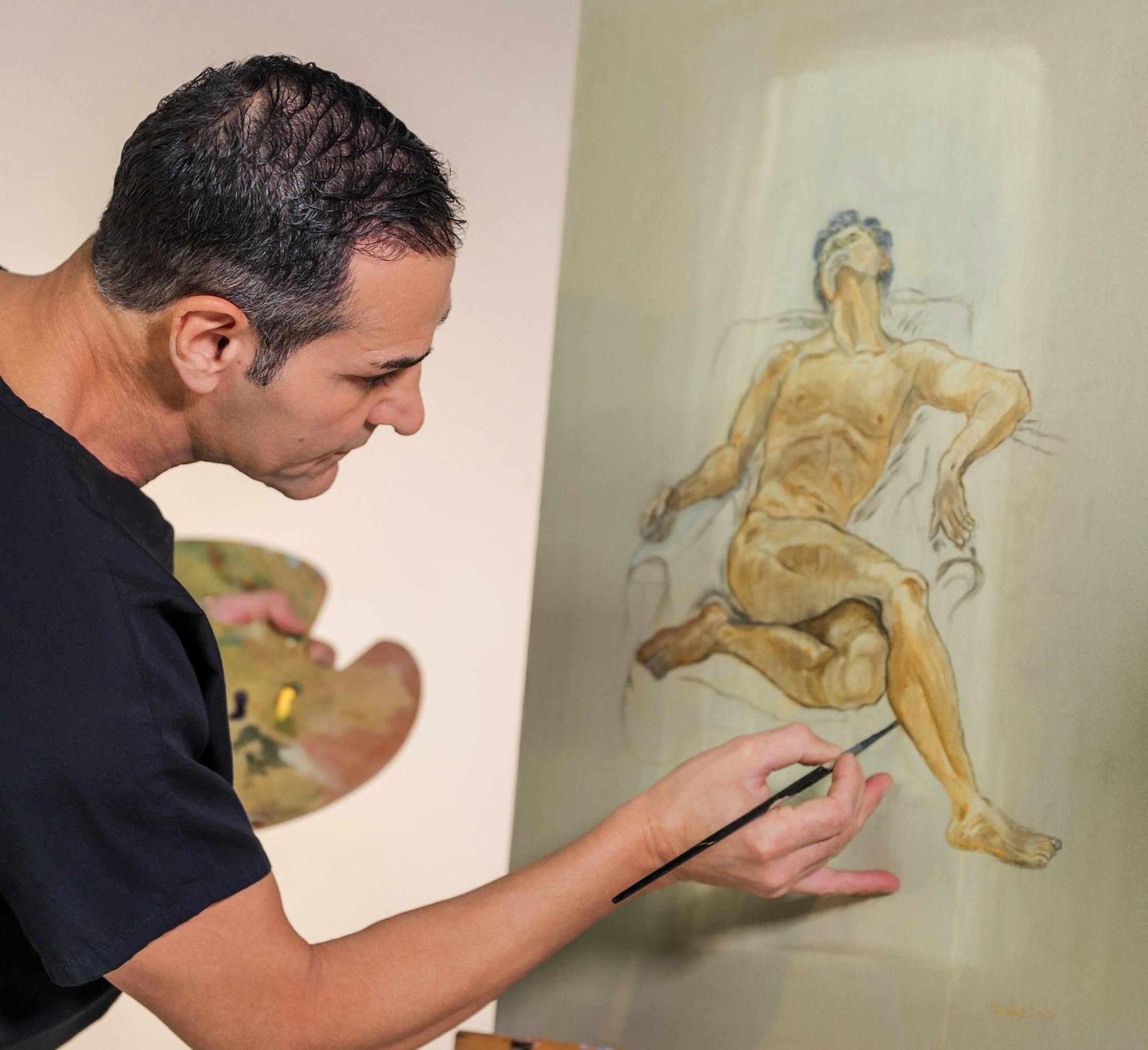Close up of Dr. Kevin Sadati painting a line of a man's calf on an aisle