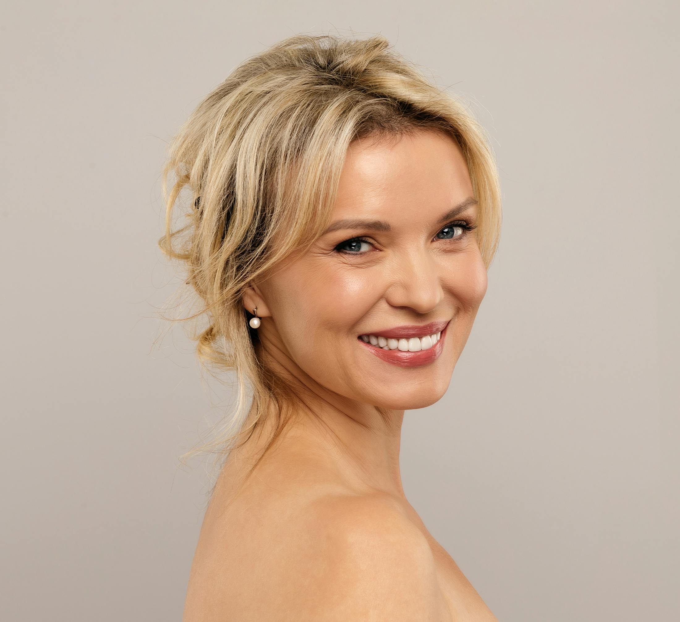 blonde woman with head looking over shoulder