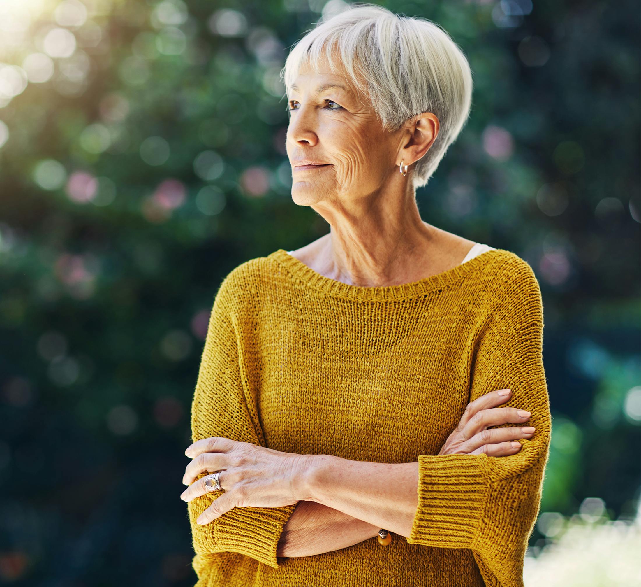 woman in her seventies with a yellow sweatshirt on