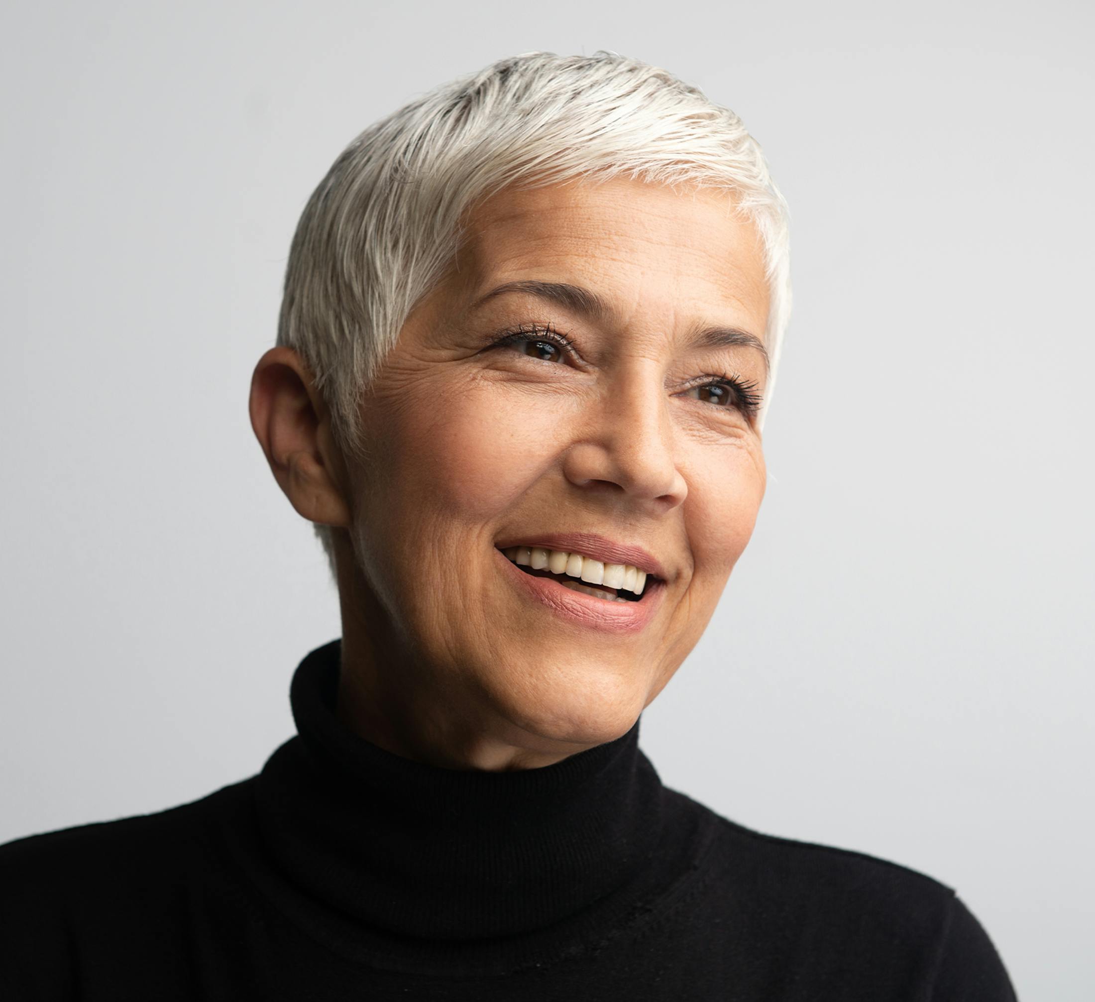 woman in her 60s in a black turtle neck shirt