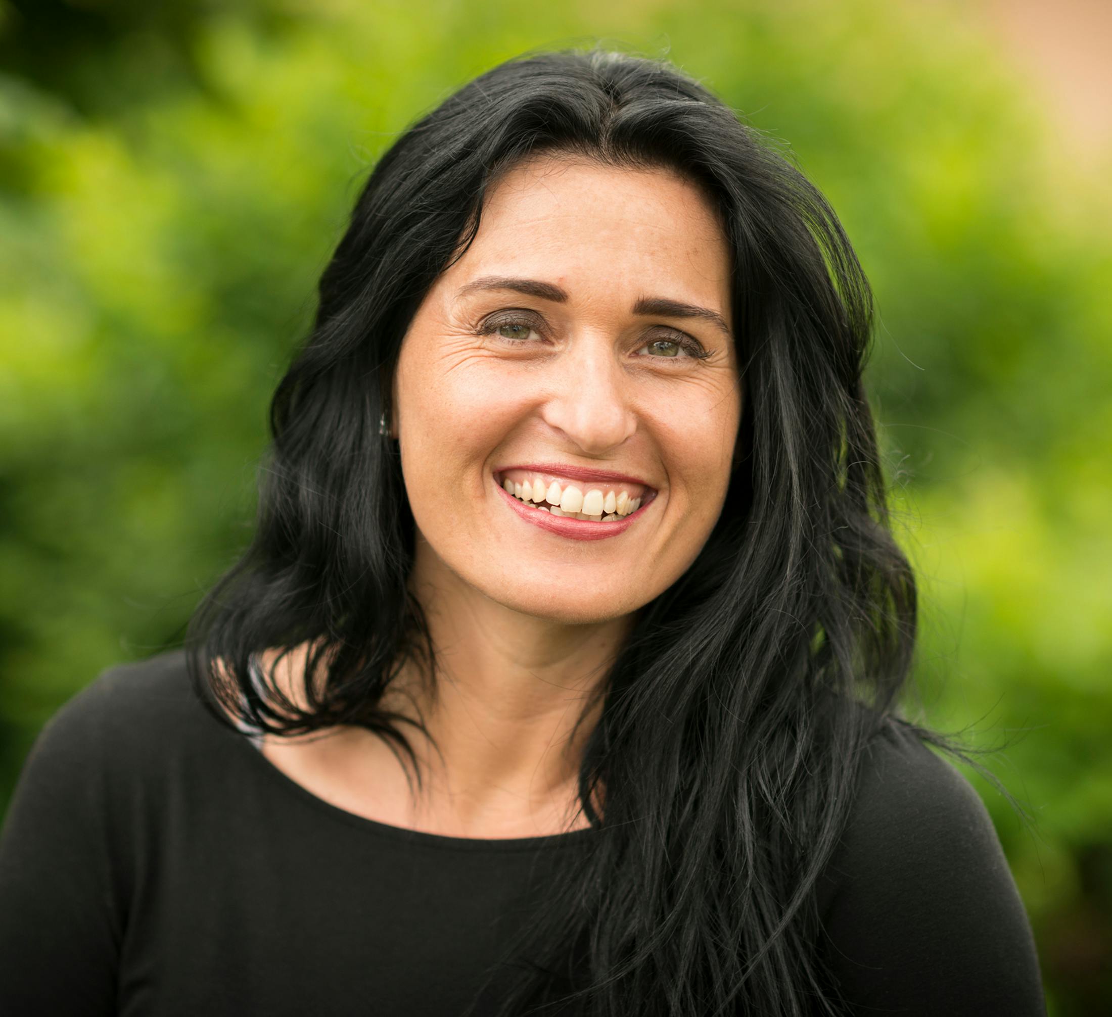 woman with long black hair and black long sleeve shirt
