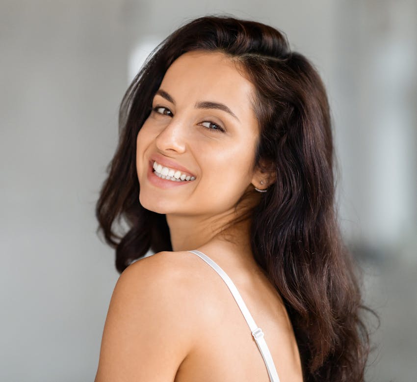woman looking over her shoulder and smiling