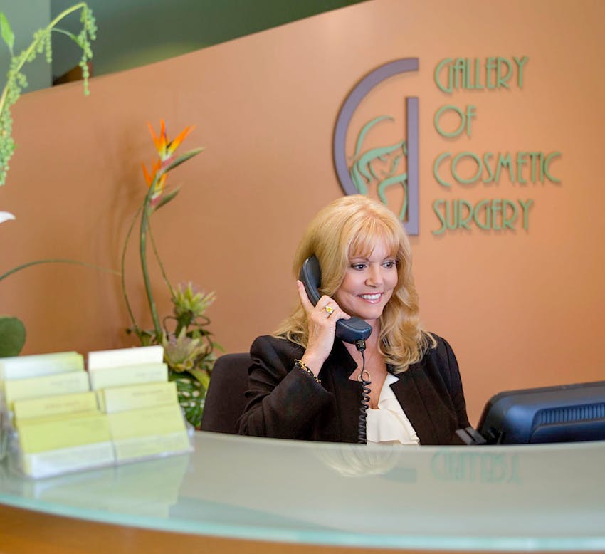 receptionist speaking on the phone at the front desk