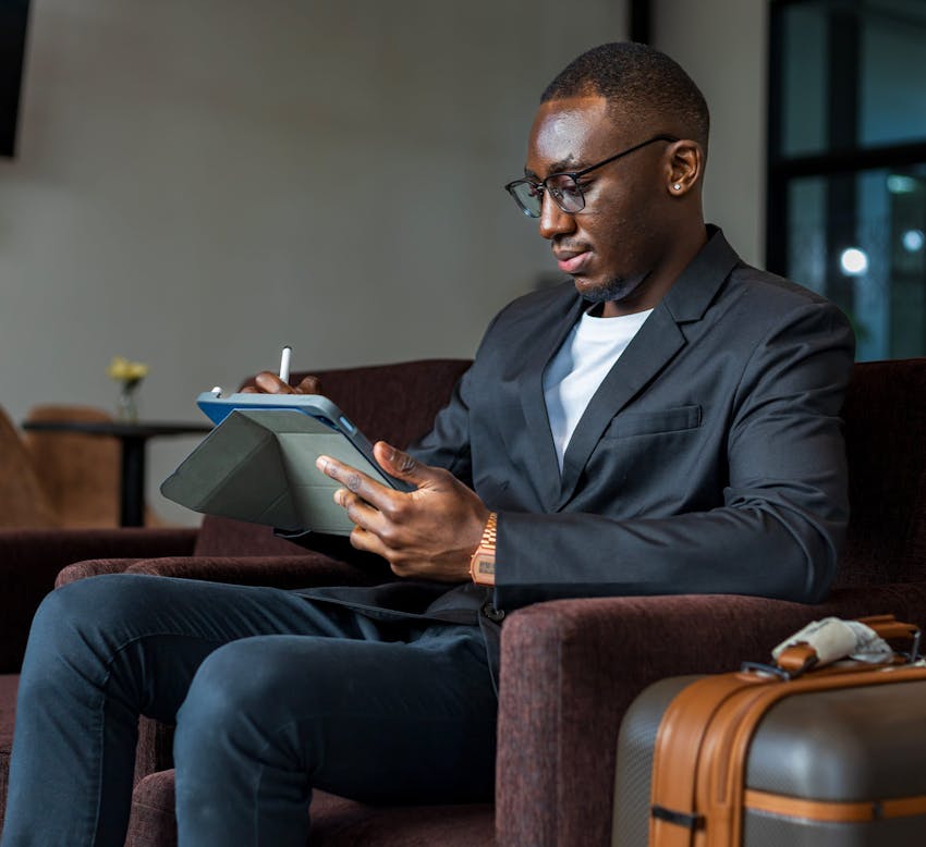 man filling out information on a tablet