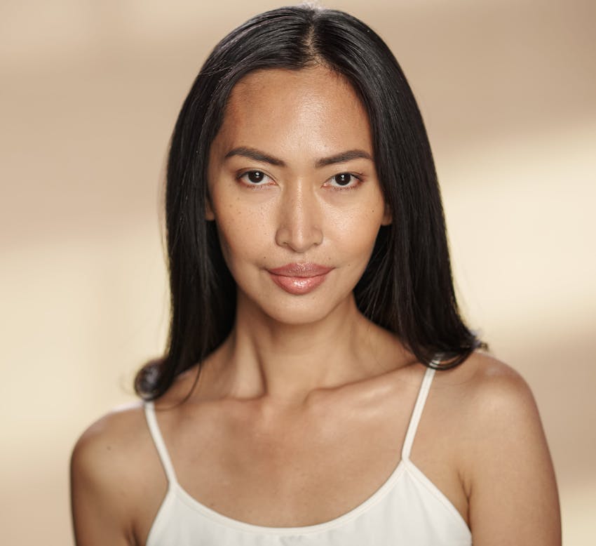 woman with long straight dark hair looking forward