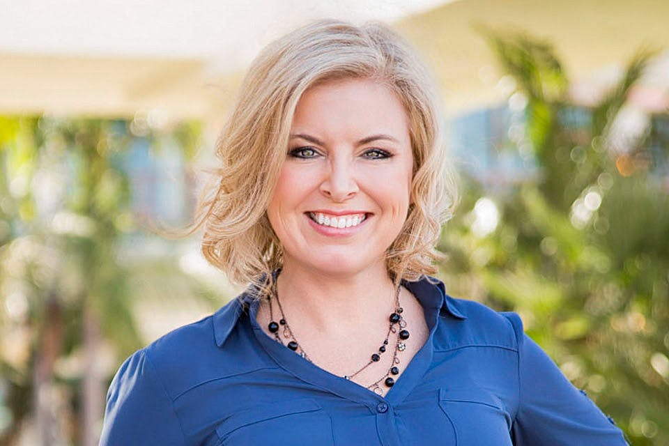woman with blonde hair wearing a blue shirt
