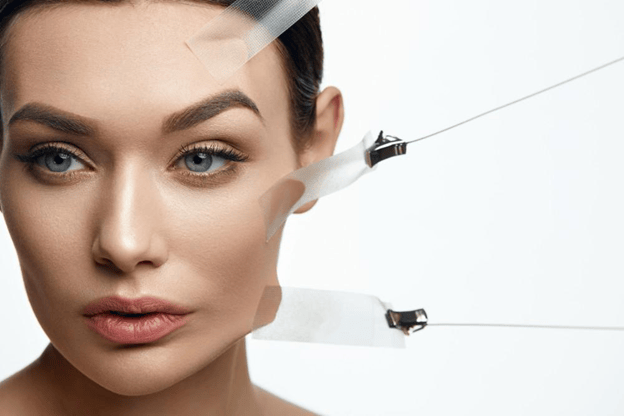 woman taping her face back