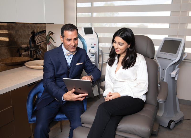 doctor and patient looking at an ipad in a consult room