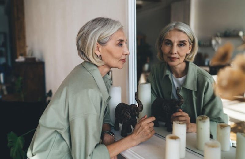 woman looking at the mirror