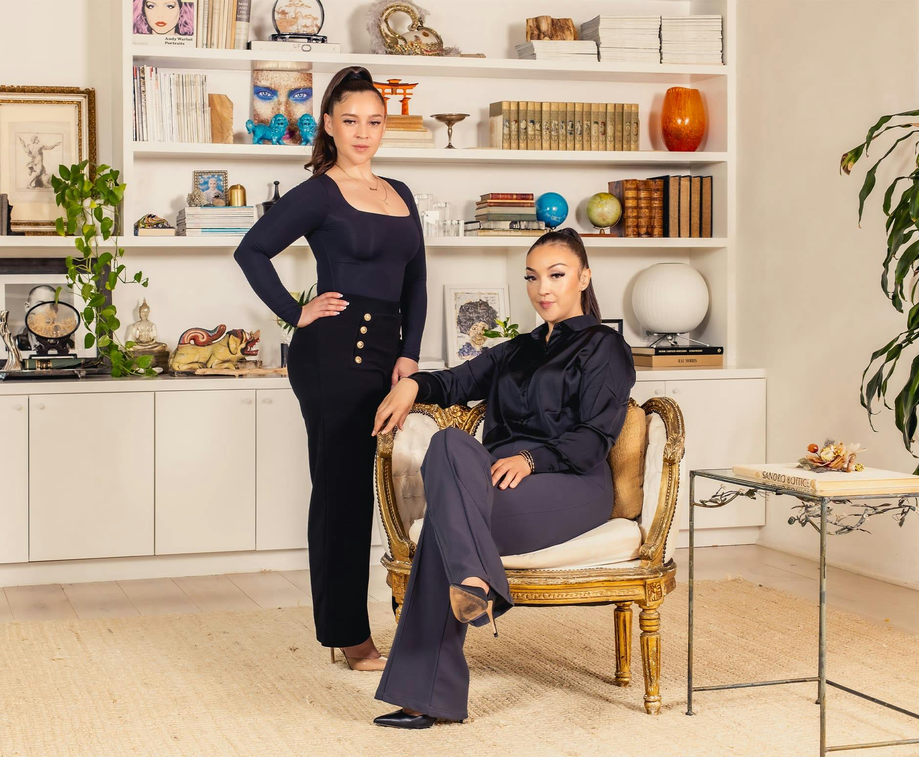 One woman sitting and one standing