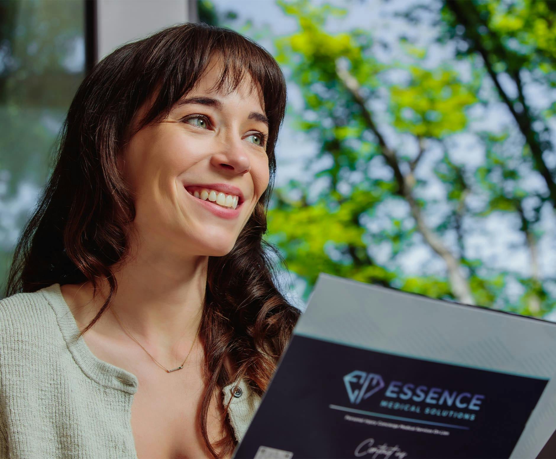 Woman smiling while holding pamphlet