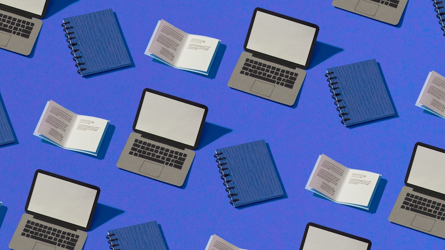 A composite image of paper laptops and binders on a blue background.