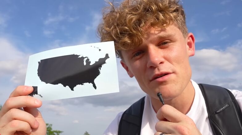 [Screenshot: Ryan Trahan holding up a US map outline against a blue sky, from the series intro]