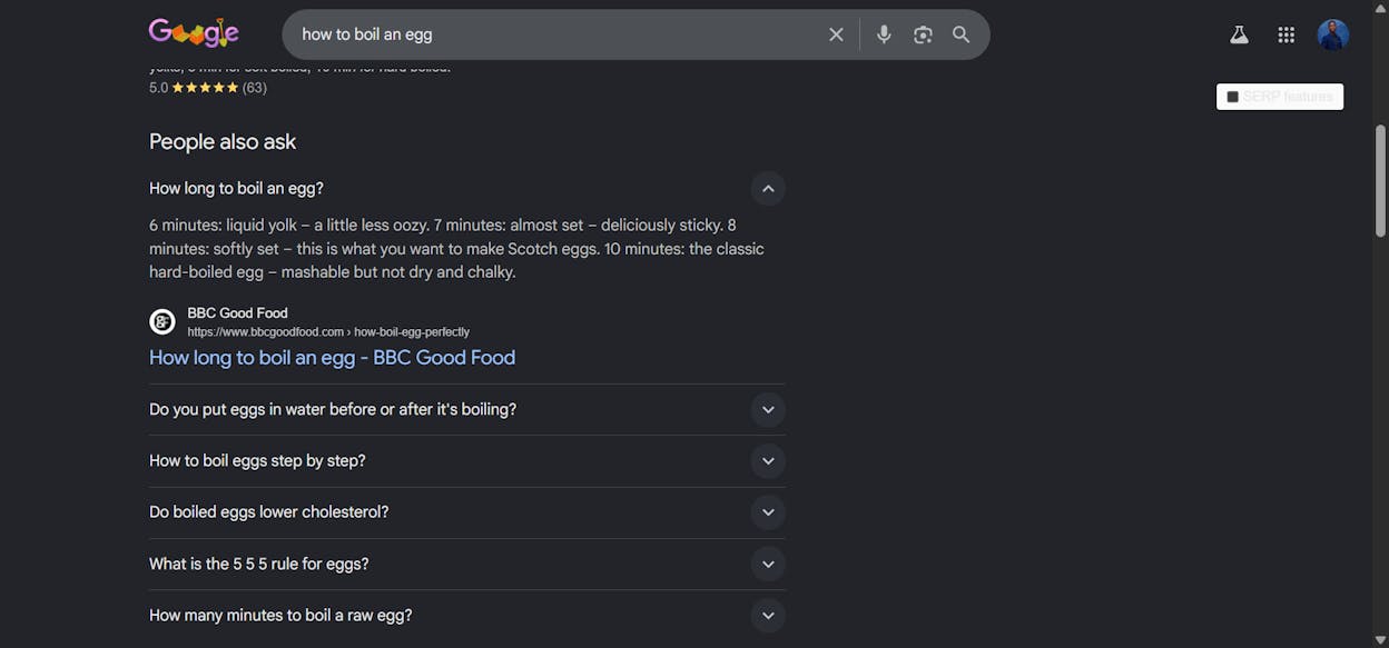 [Screenshot description: Google SERP showing a People Also Ask box expanded to reveal an answer with a clickable source link]
