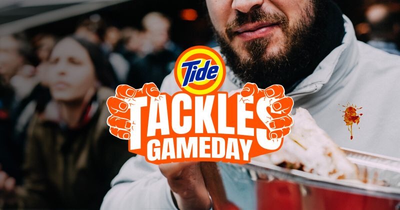 [Screenshot: A scene from a #TideTackles social video showing an NFL legend at a tailgate party.]